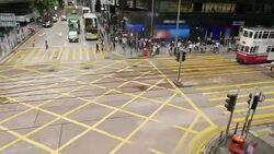 Time lapse of people and vehicles at pedestrian crossing intersection on busy road Stock Footage