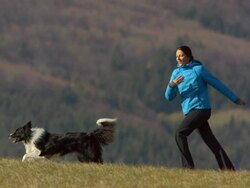 HD Super Slow-Mo: Young Woman Running With Her Dog Stock Footage