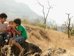 Three Kids eating corn at hill station Stock Footage