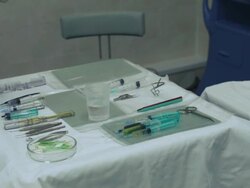 Operating room Nurse puts Syringe on table with medical tools Stock Footage