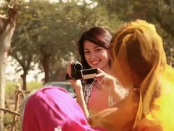 Young woman talking video of two rural women near handpump, Haryana, India Stock Footage