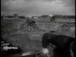 1936: BELGIUM: FORTIFICATION CONSTRUCTION: WS Construction site, digging fortification. WS Construction materials, metal beams, on field. HA WS Belgian workers shoveling fortification construction. Instructional Video