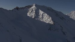 Shadows cover a snowy mountainside. Stock Footage