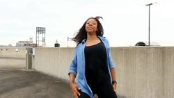 MS ZI ZO Female dancer dancing on building rooftop with cityscape in background Stock Footage