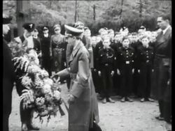 Goebbels visits a cemetery where Dutch and German soldiers are burried and lays a wreath at a memorial stone Stock Footage