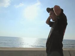 MS POV Two men's skateboarding on side walk near beach area / Chatan, Okinawa, Japan Stock Footage