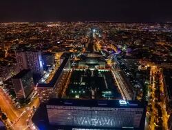 High view on Montparnasse train station and Paris at night tilt Stock Footage