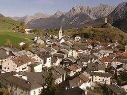 WS AERIAL View of Ardez with its typical engadin houses and steinberg castle on hill / Ardez, Upper Engadin, Switzerland Stock Footage