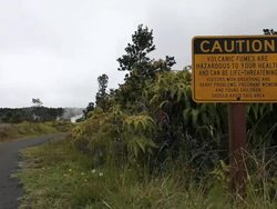 MS Shot of young man in hiking clothes walking away from path beside caution sign regarding dangerous volcanic fumes at steam vents in Volcanoes National Park / Volcano, Hawall, Big Island, United States Stock Footage