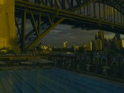 T/L MS PAN ZI Day turns to night and lights come on, swimmers doing laps in North Sydney Olympic Pool in shadow of Sydney Harbour Bridge / Sydney, New South Wales, Australia Stock Footage