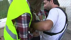 Refugee child being looked at by medical volunteer News Clip