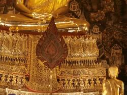 MS TD Golden Buddha statue in temple with worshippers / Bangkok, Thailand Stock Footage