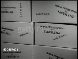 1950: YUGOSLAVIA FOOD AID ARRIVES: HA WS Port of Fiume. WS Ship 'Makedonija' in dock. MS Boxes '..Yugoslavia.' EXT WS People walking on stairs. INT MS Yugoslavian family having dinner. VS Elderly couple reading newspaper, having a drink. Croatia Instructional Video