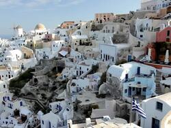 The white washed homes in the town of Oia with a view overlooking the Aegean Sea on the Island of Santorini, Greece, Europe Stock Footage