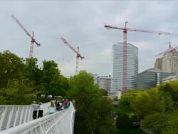 WS T/L Clouds over cranes and tower in construction site with pedestrian in park  / Oklahoma city, Oklahoma, USA Stock Footage