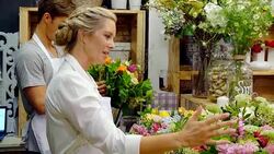 Florist and customer discussing and arranging bouquet in flower shop Stock Footage