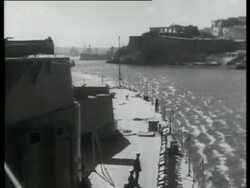 The Queen Elizabeth, flagship of the Commander-in-chief, Mediterranean, leaves Malta harbour, Malta, 1939 Stock Footage