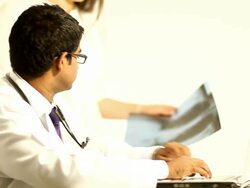 Doctor typing on Laptop then checking an X-Rays Lungs Stock Footage