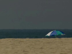 MS Venice Beach with beach umbrella / Los Angeles, California, United States. Stock Footage