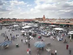 WS POV T/L Djemaa el-Fna square crowded with people and tourist doing shopping  / Marrakech, Morocco Stock Footage