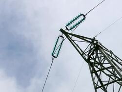 Electrical tower with cloudscape zoom out Stock Footage