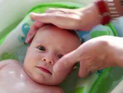 CU Shot of mother giving her baby bath / Lamy, New Mexico, United States Stock Footage