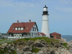 WS Shot of Portland Maine famous Head Light Lighthouse in USA on water with rocks and ocean on cliff / Portland, Maine, United States Stock Footage