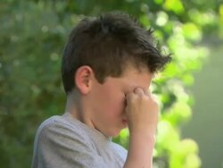 Boy rubbing his eyes Stock Footage