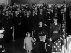 B/W 1963 Jacqueline + Caroline Kennedy approach John Kennedy's coffin + kneel down / newsreel Stock Footage