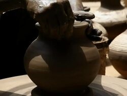 Man making a earthen pot on a pottery wheel  Stock Footage