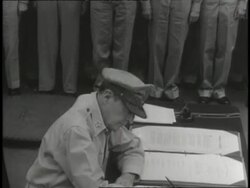 U.S. General Douglas MacArthur signs the Japanese surrender then gives the pen to British General A.E. Percival aboard the USS Missouri. News Clip