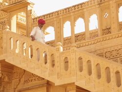 Rajasthani senior man moving down from stairs, Amar Sagar Jain Temple, Jaisalmer, Rajasthan, India Stock Footage