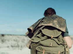 Backpacker walking through the desert Stock Footage