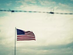 American Flag behind barbed wire Stock Footage