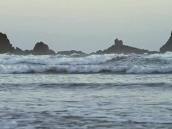 WS PAN SLO MO View of beautiful low shot of waves on rocky Pacific Northwest coast of Oregon at dusk / Astoria, Oregon, United States  Stock Footage