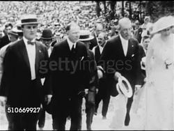 1920: POLITICS: President Woodrow Wilson (1856-1924) walking up steps w/ second wife Edith Bolling Galt & unidentified men, large crowd BG. MS Dome of Capitol Building. President Wilson at desk writing, POOR FOCUS Wilson sitting in chair. Instructional Video