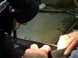 Hands and needle sewing zip in place, CU, United Kingdom Stock Footage