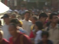 WS PAN Boy walking on street with spitual wadi in hand Audio / Kathmandu, Central region, Nepal Stock Footage