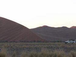 Vehicle parked next to dune, Sossusvlei, Namib-Naukluft, Namibia Stock Footage