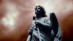 The statue of an Angel on time lapse clouds (Loop). Stock Footage