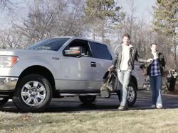 MS Two young men hitting golf balls on ridge with their truck behind them / Stillwater, Minnesota, United States Stock Footage