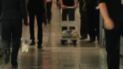 People walk through revolving door at airport Stock Footage