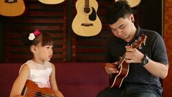 Ukulele Guitar teacher teach music Stock Footage