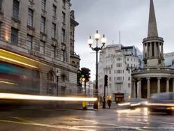WS T/L ZI View of Traffic and pedestrians passing on regent street near souls and BBC broadcasting house and Langham Hotel on wet winters evening / London, Greater London, United Kingdom Stock Footage