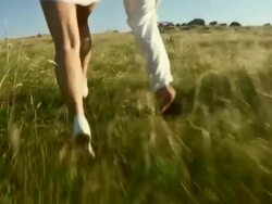 SLO MO Couple Running On A Meadow Stock Footage