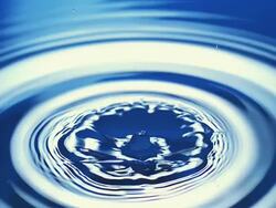 MS SLO MO Shot of Drop of water falling into water against blue background / Vieux Pont en Auge, Normandy, France Stock Footage