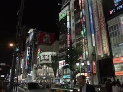 PAN Buildings and people in Shinjuku, Tokyo, Japan. Stock Footage