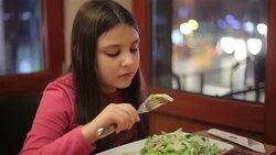 little girl eating in restaurant Stock Footage