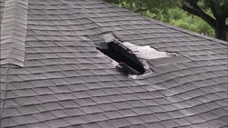 Storm damage is evident on the roof of an abandoned home after Hurricane Katrina. Stock Footage
