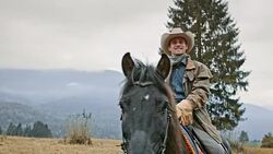 SLO MO Portrait of cowboy stroking horse's neck Stock Footage